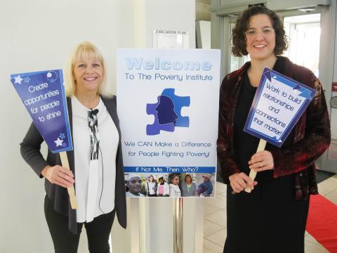 Donna Beegle and Michele Jersak posing with signs